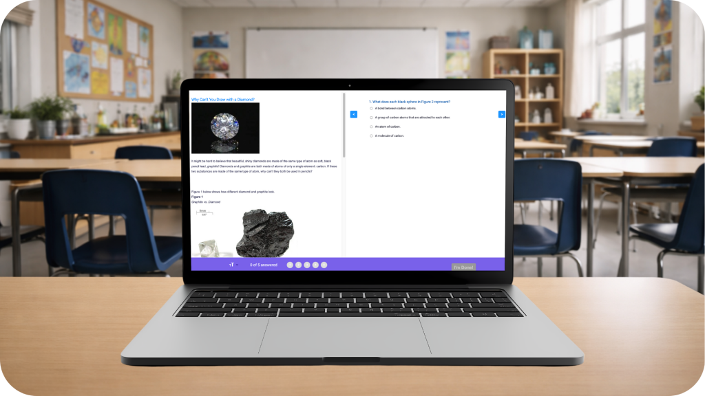 A laptop sits on a student desk in a middle school science classroom, showing an NGSS-style assessment with a phenomenon about diamonds and graphite, reading content on the left, and multiple-choice questions on the right. The classroom background includes student desks, chairs, a whiteboard, and shelves with science materials, with no people present.